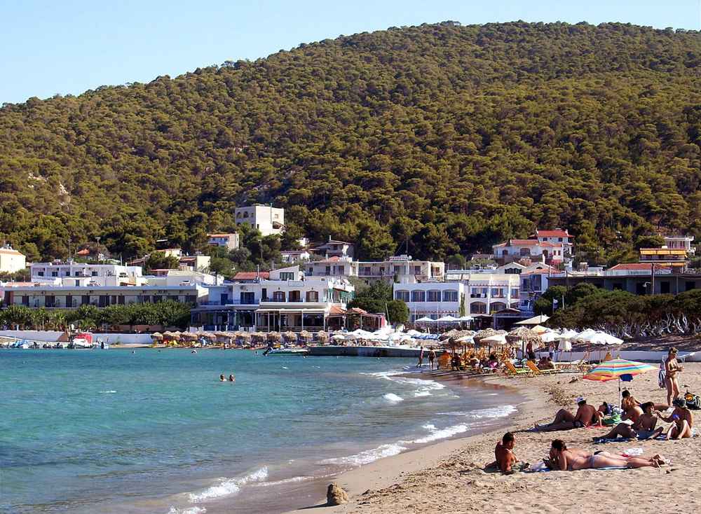 The sandy beach of Skala on Agistri, backed by pine forest, near Aegina