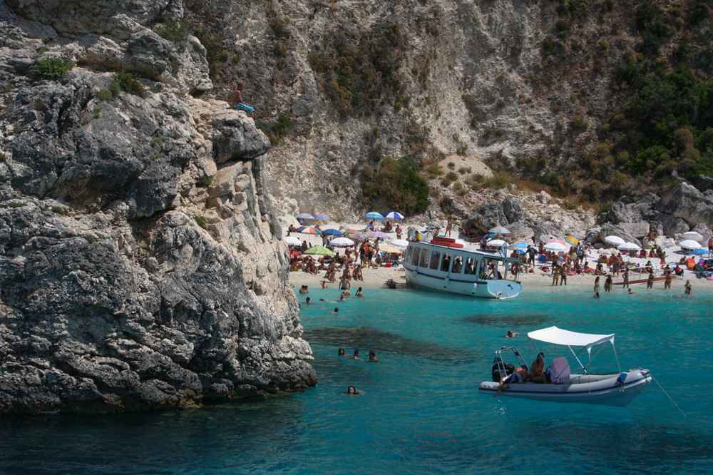 The taxi boat arriving at Agiofili beach below the cliffs, Lefkada