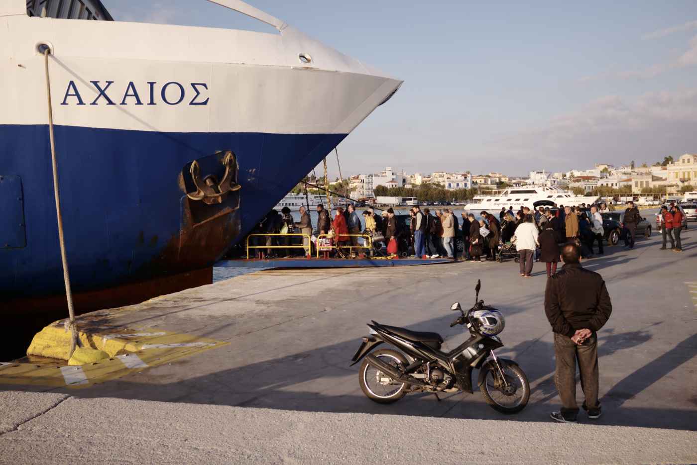 A ferry docked at the harbour of Aegina Town with passengers disembarking