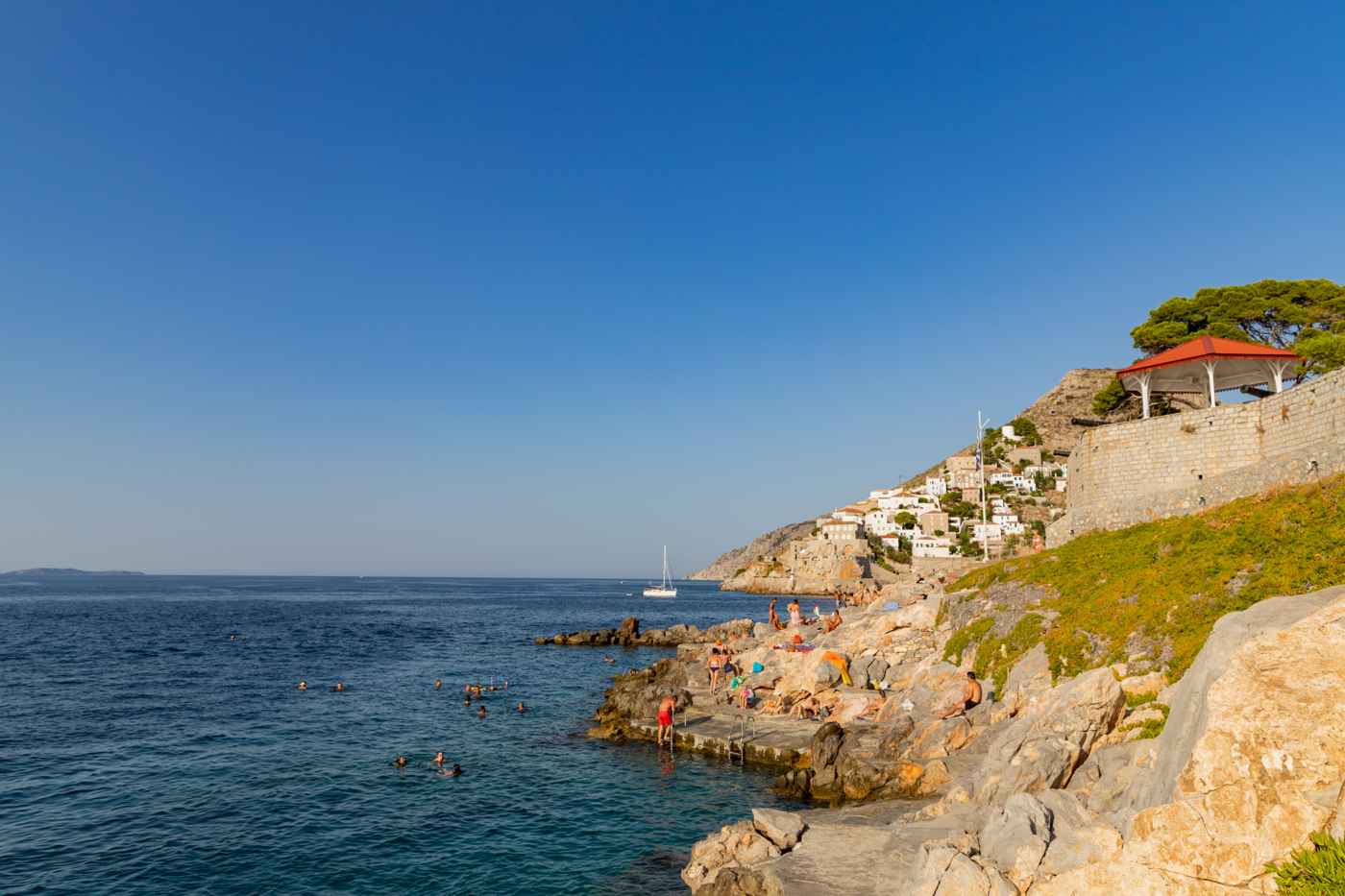 Summer swimming off the rocks near Hydra town, one guide to the best time to visit Hydra