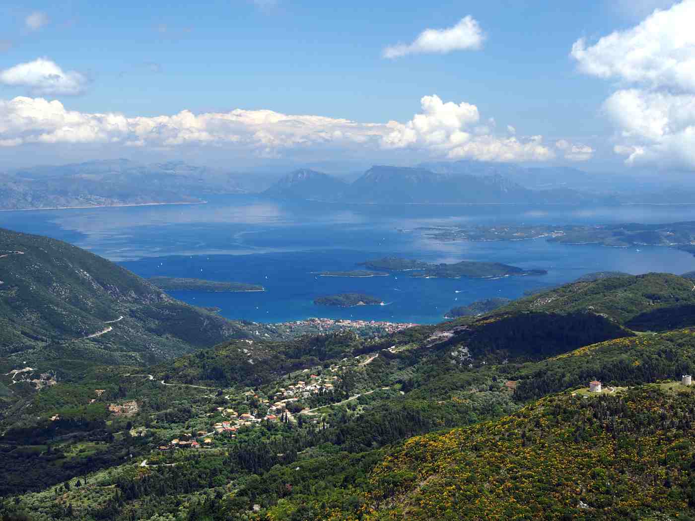 A view over the green hills and east coast of Lefkada toward the Ionian islets