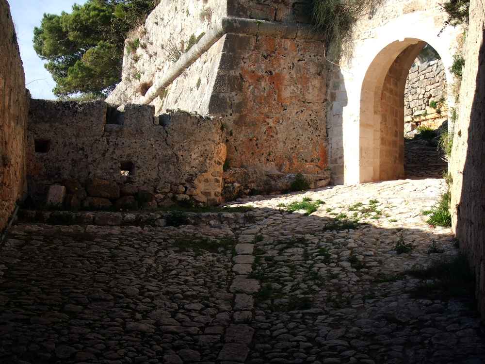 Cobbled courtyard and gate inside the Castle of Saint George, Kefalonia