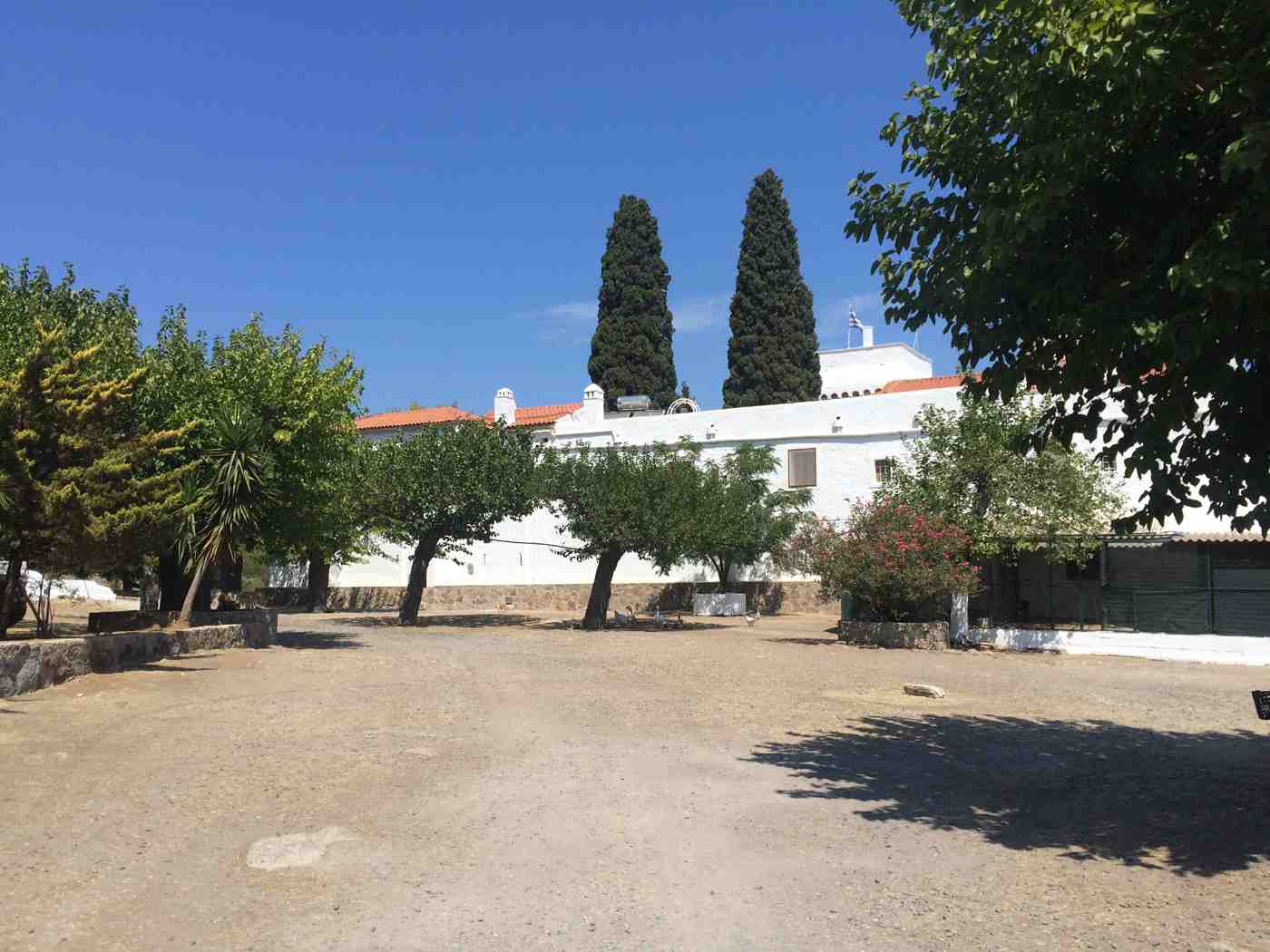 The fortified Monastery of Chrysoleontissa with its cypresses in the hills of Aegina