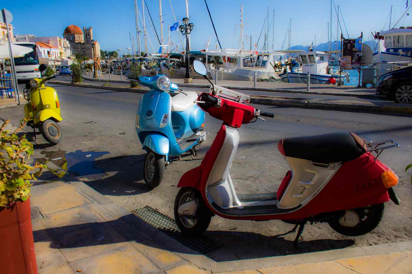 Rental scooters parked on the harbourfront of Aegina Town