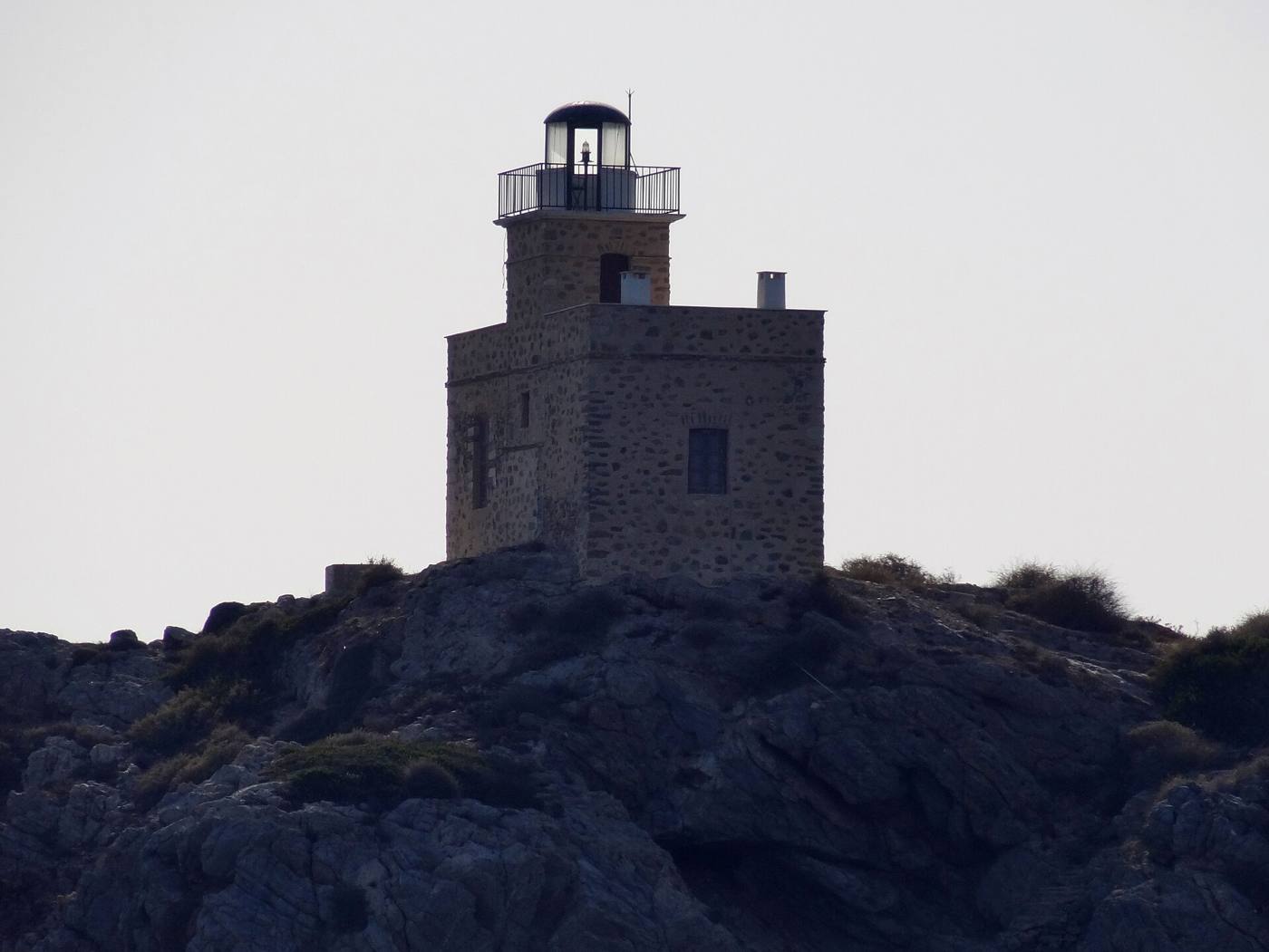 The stone lighthouse guarding the harbour approach to Ios