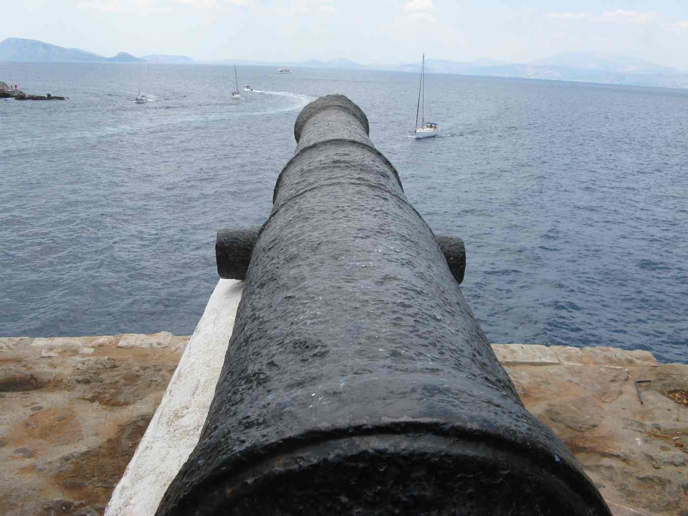 A historic cannon guarding Hydra harbour, a relic of the island and its Hydra history