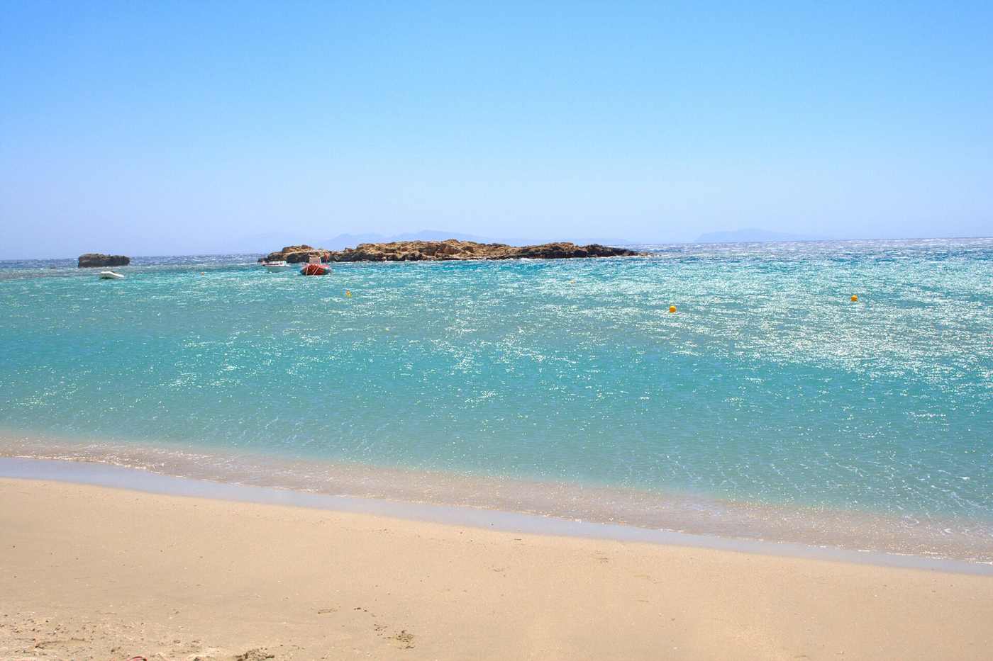 The turquoise water and sandy coves of Manganari beach in the south of Ios