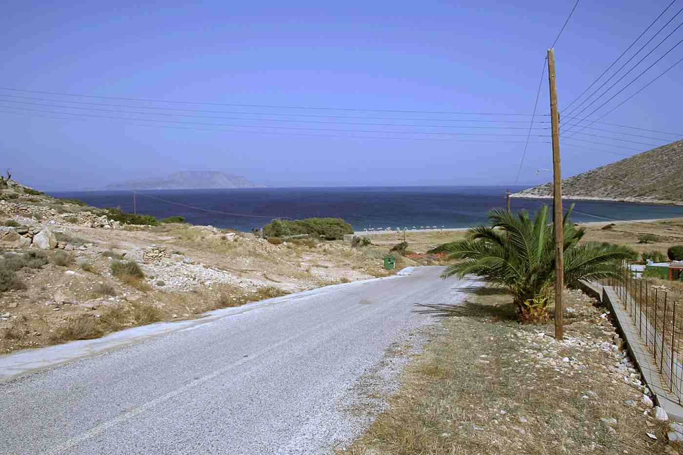 A road descending to a beach on Ios, easily explored with your own hire vehicle