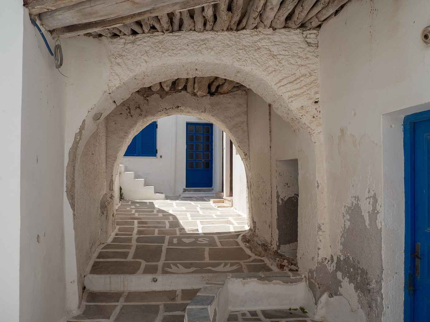 A whitewashed, marble-paved alley in Chora, the hilltop town of Ios
