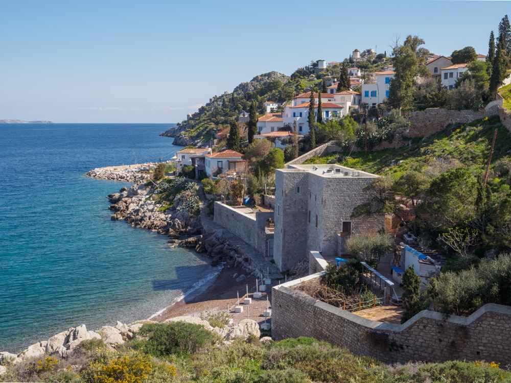 Kamini Hydra: the fishing village, old fort and pebble beach along the turquoise coast