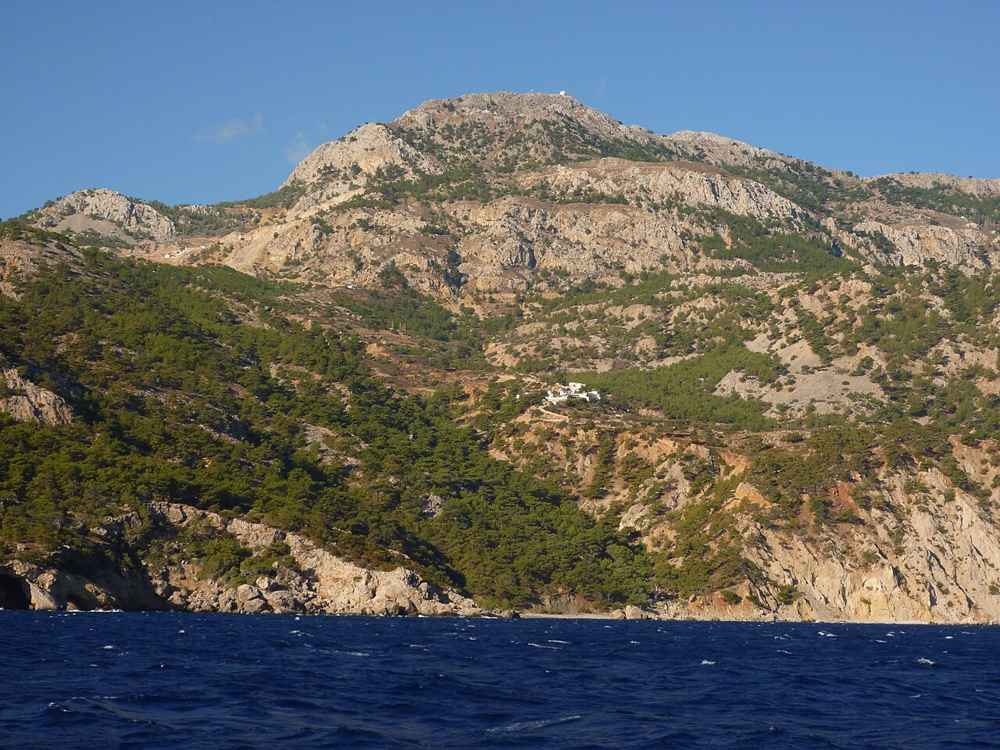 The rugged, wind-swept coast of Karpathos seen from the sea