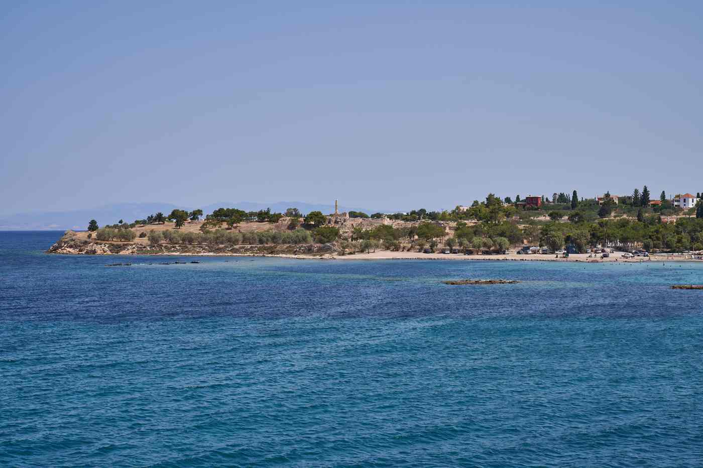 The Kolona acropolis and its lone column above Kolona beach, seen from the Saronic Gulf