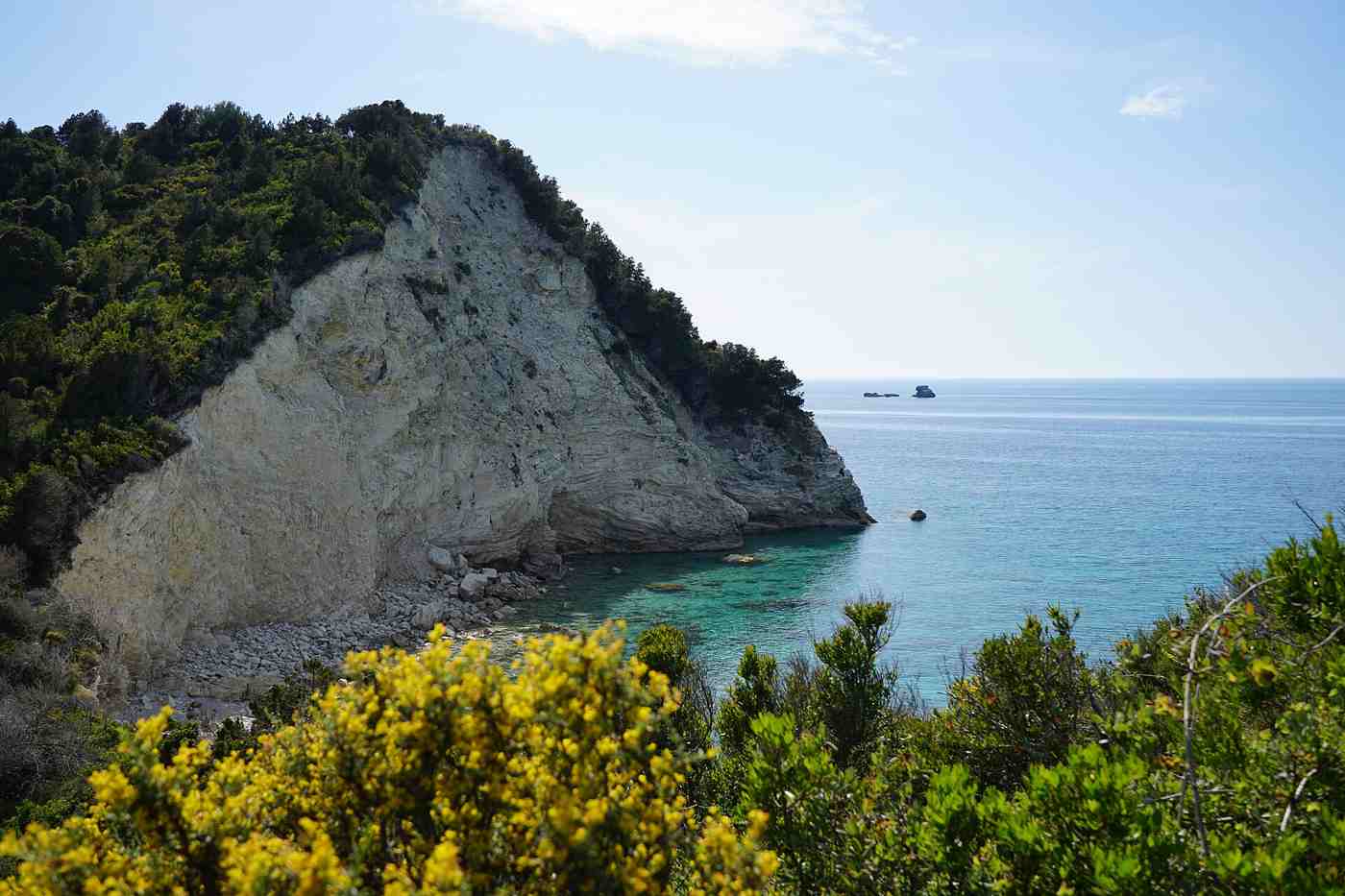 A white cliff and clear-watered cove near Lakka on Paxos