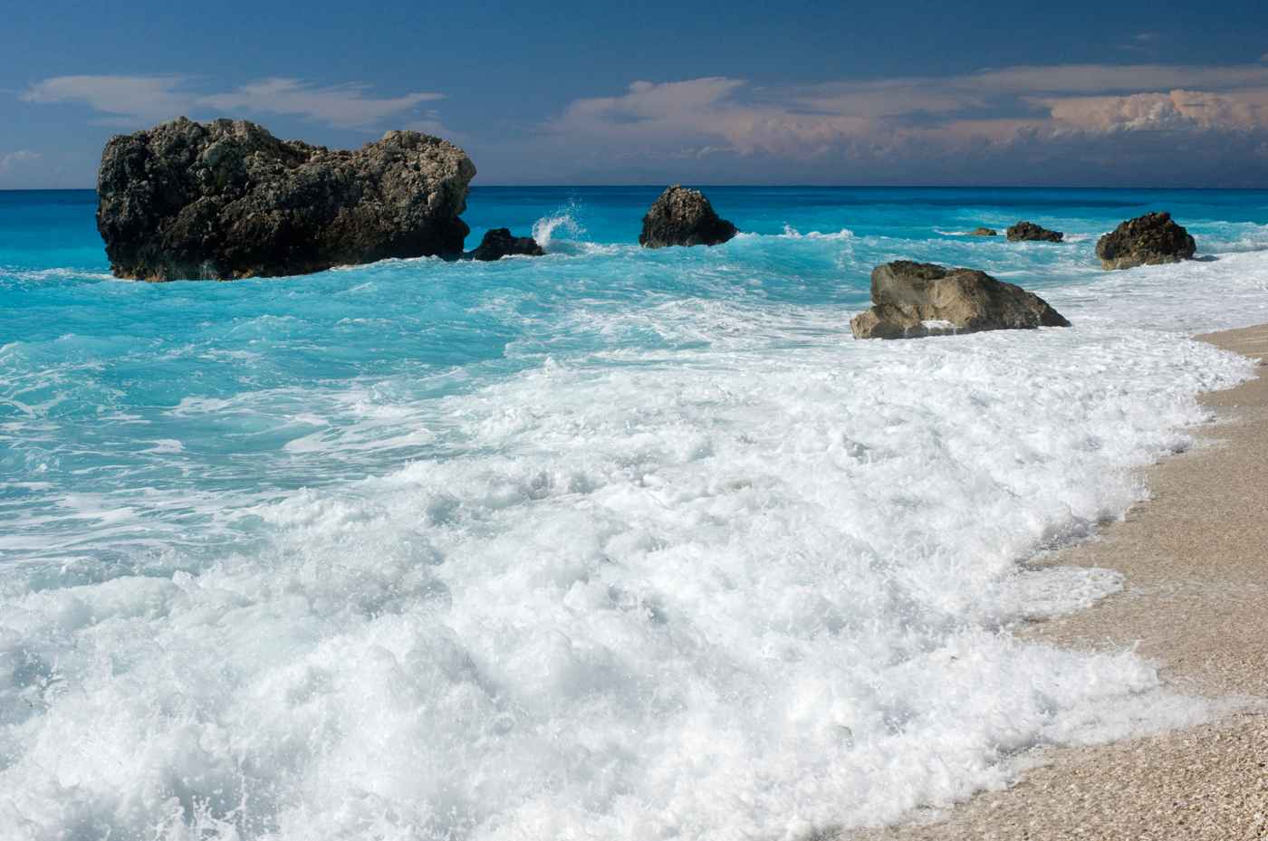Turquoise water and white pebbles at a quiet west-coast beach on Lefkada
