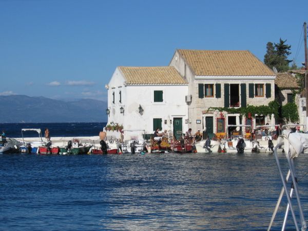 The harbour of Loggos on Paxos with stone houses and moored boats