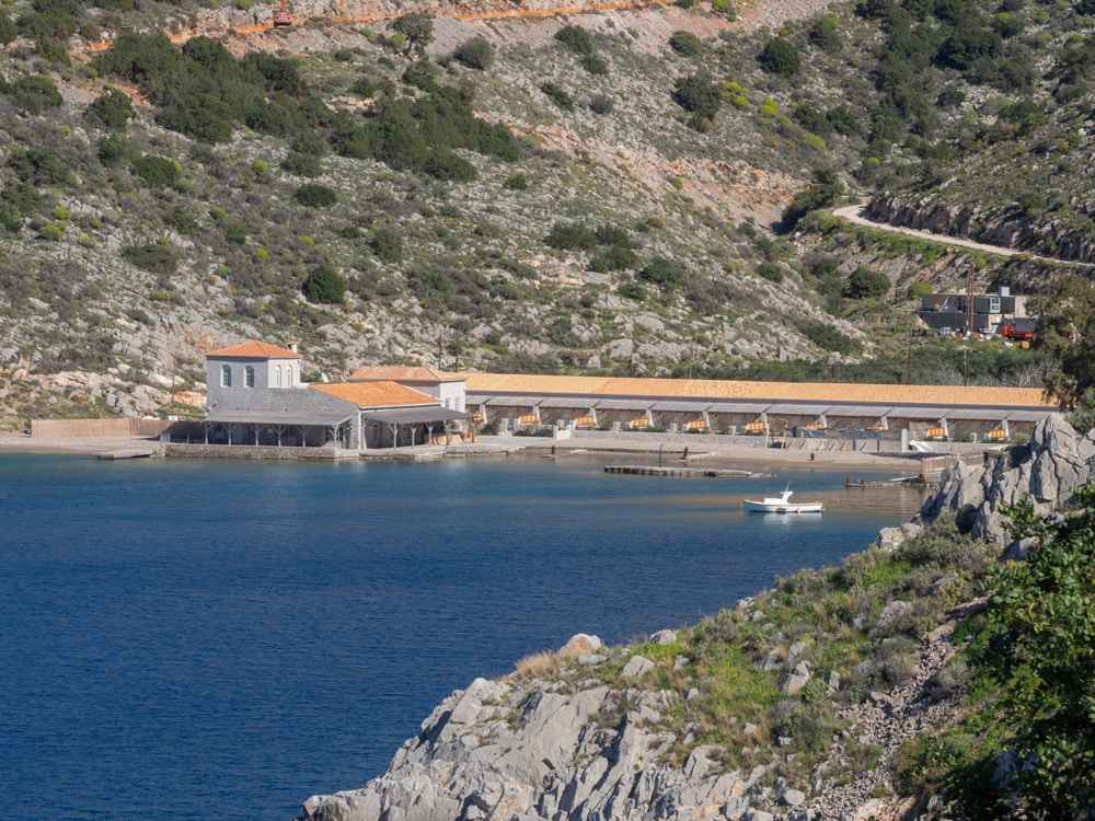Mandraki bay on Hydra, home to the island's only sandy beach and its resort on a former naval station