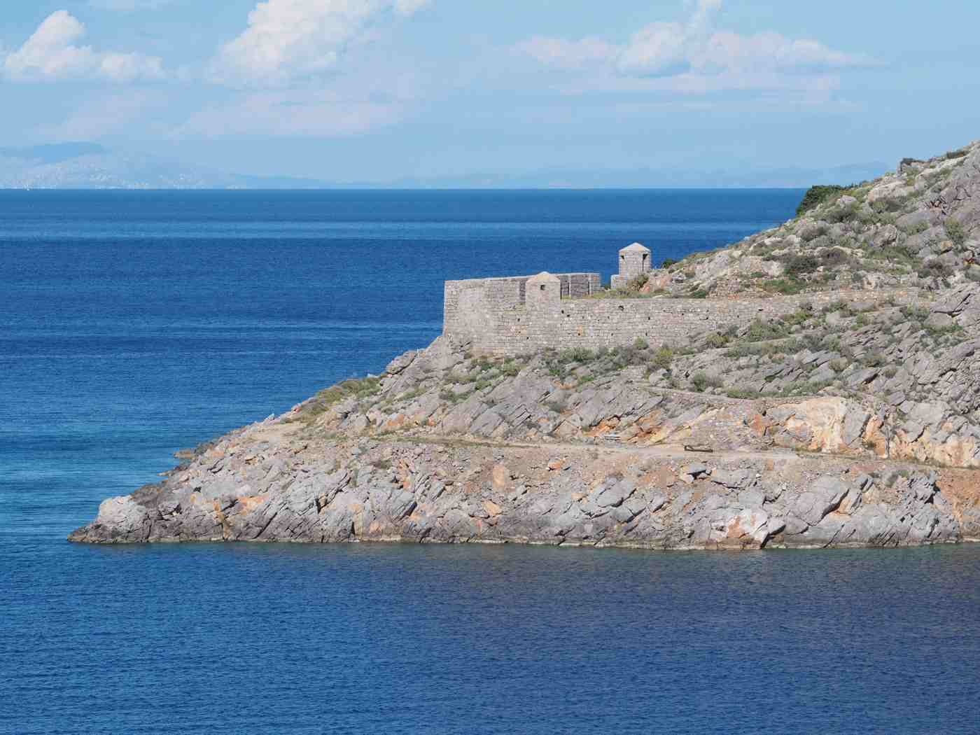 The old stone naval fortification at Mandraki, Hydra, on whose site the beach resort was built