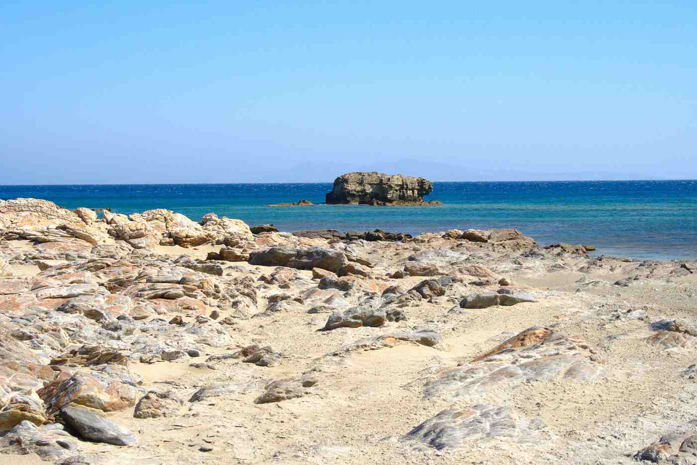 A sandy cove of Manganari with clear turquoise water in the south of Ios