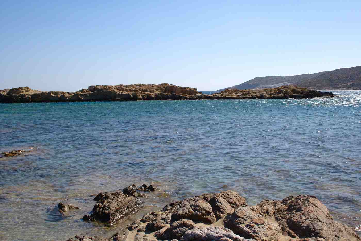 The unspoilt coves and blue sea of Manganari beach on Ios