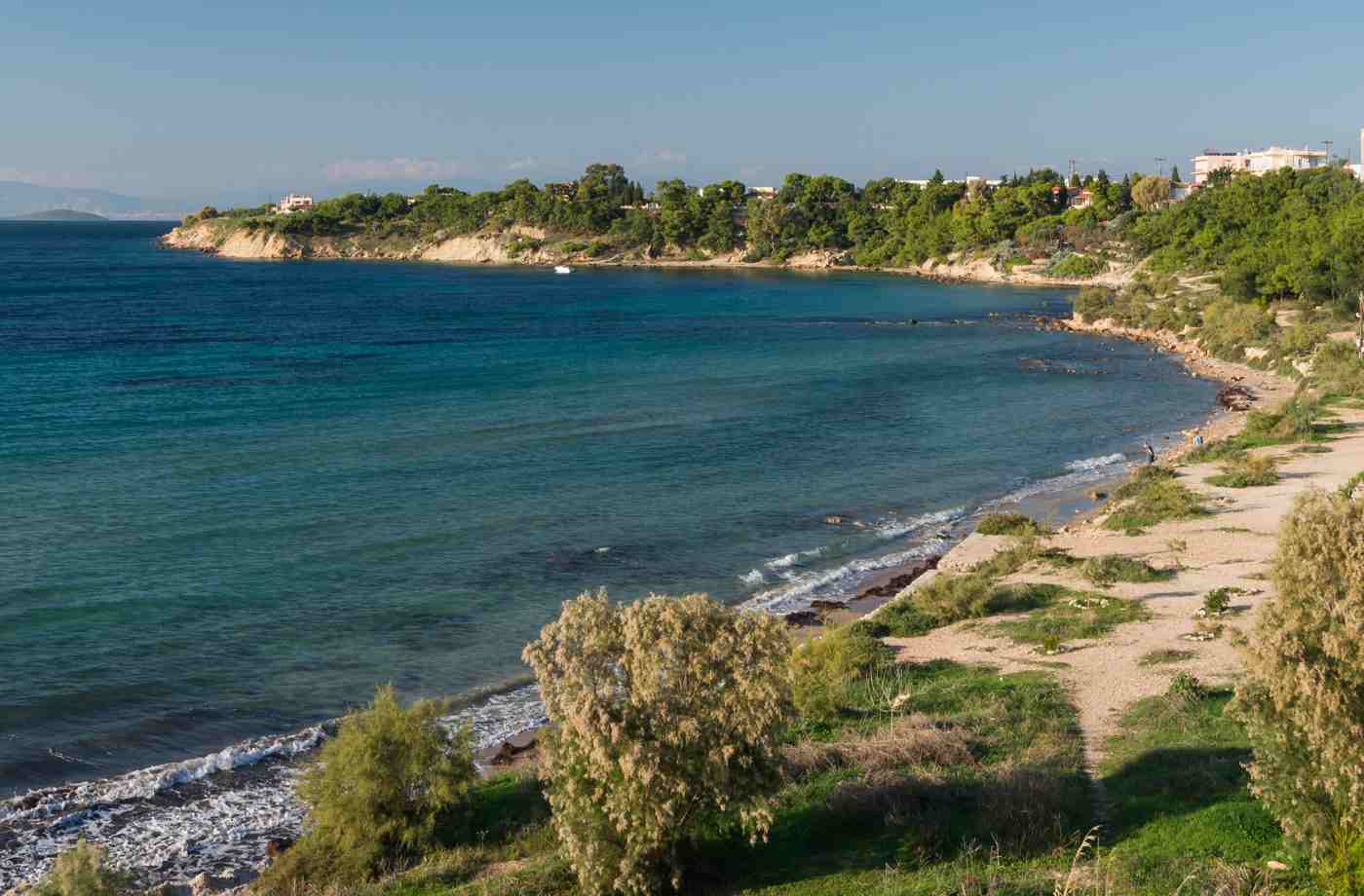 A sandy bay and calm clear water on the west coast of Aegina