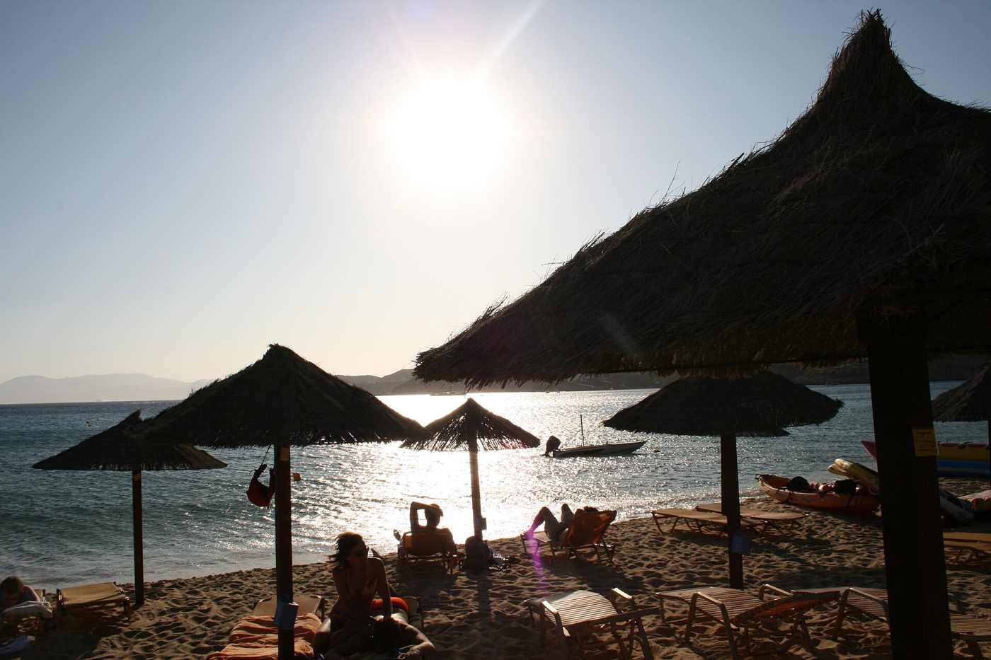 Sunbeds and thatched umbrellas on Mylopotas, the main beach of Ios