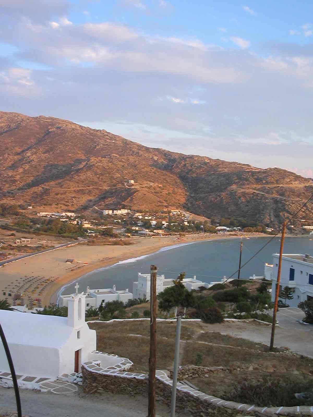 The long golden sand and clear water of Mylopotas beach on Ios