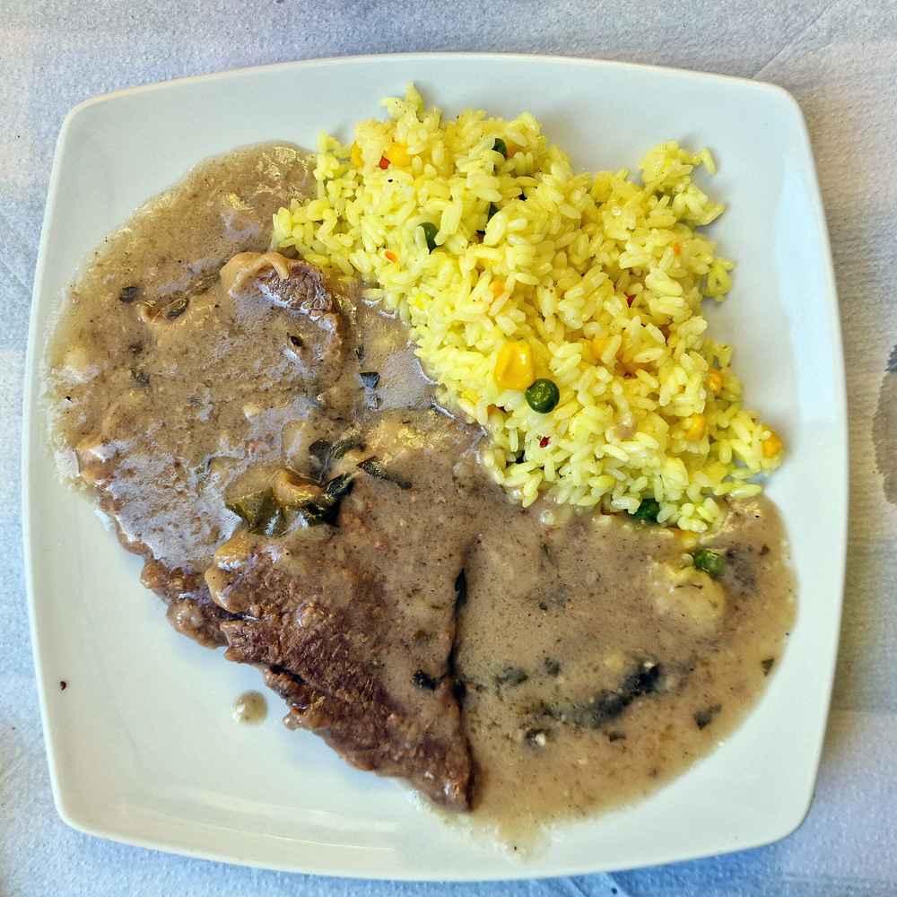A plate of sofrito, the traditional Ionian beef dish, with rice