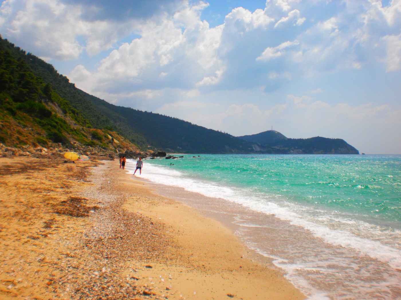 The long golden sand and turquoise water of Pefkoulia beach on the west coast of Lefkada