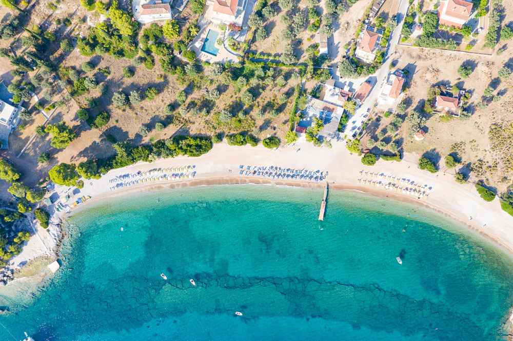 Spetses, Greece — Top-down aerial of Agioi Anargyri Beach on Spetses island, G
