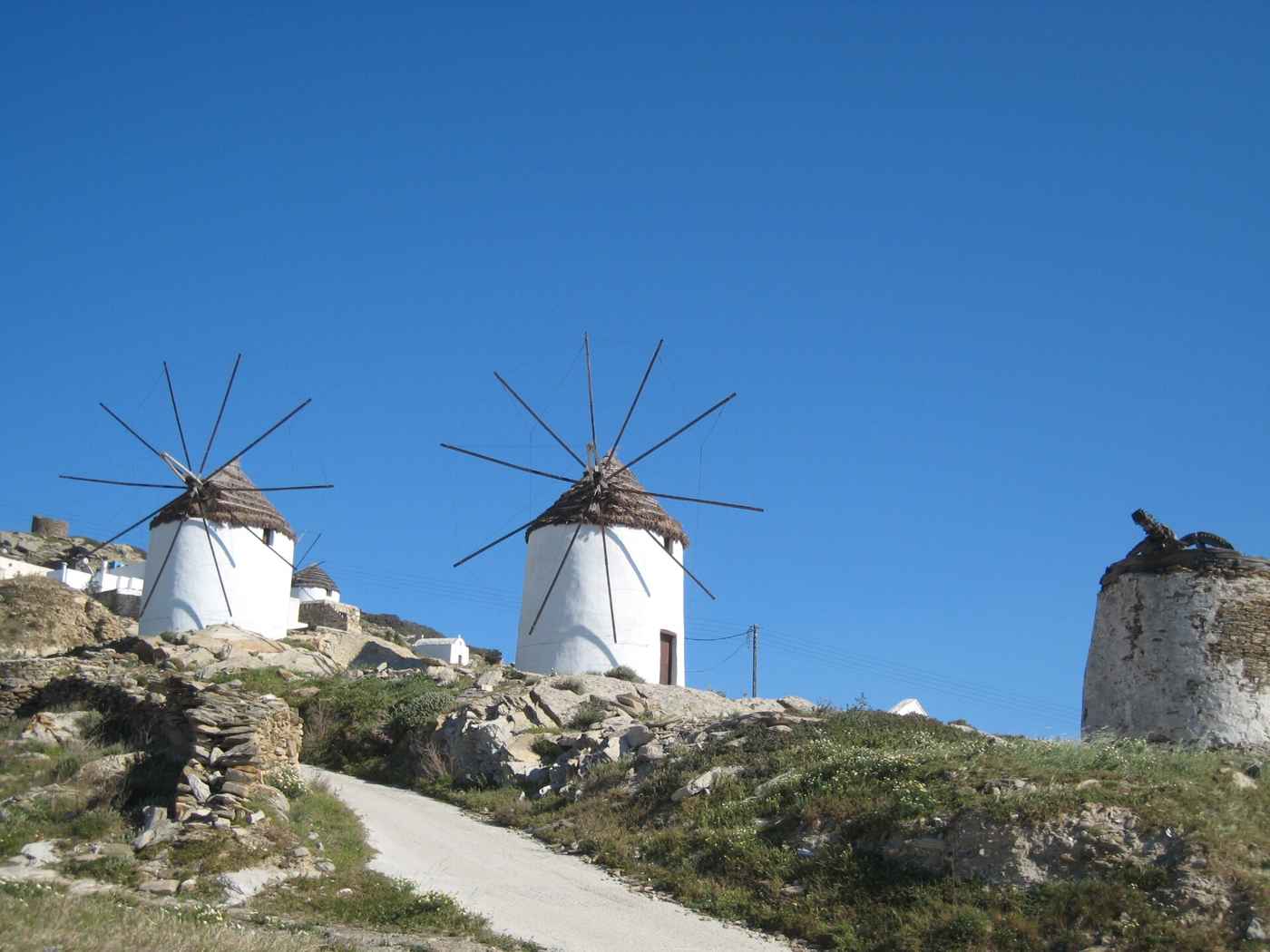 The whitewashed windmills crowning Chora, the hilltop town of Ios