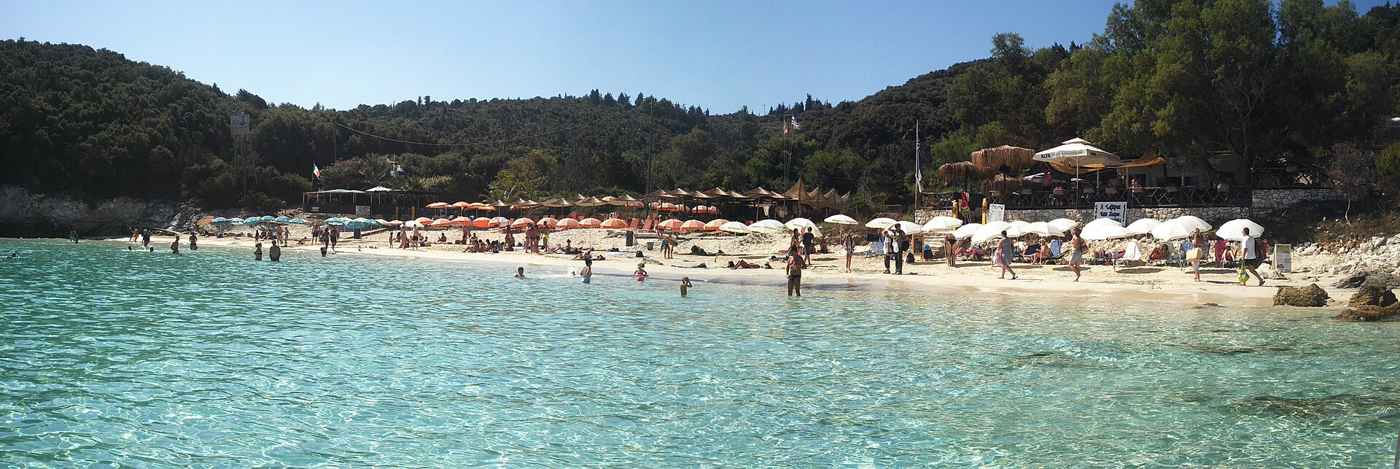 The sandy Vrika beach on Antipaxos with sunbeds and clear turquoise water
