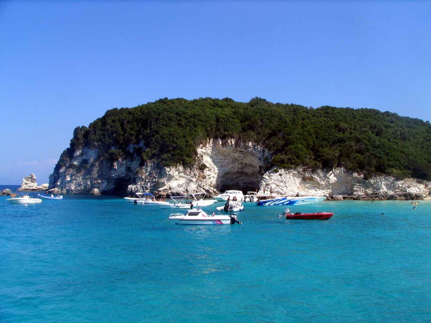 Small boats in the turquoise bay at Vrika on Antipaxos