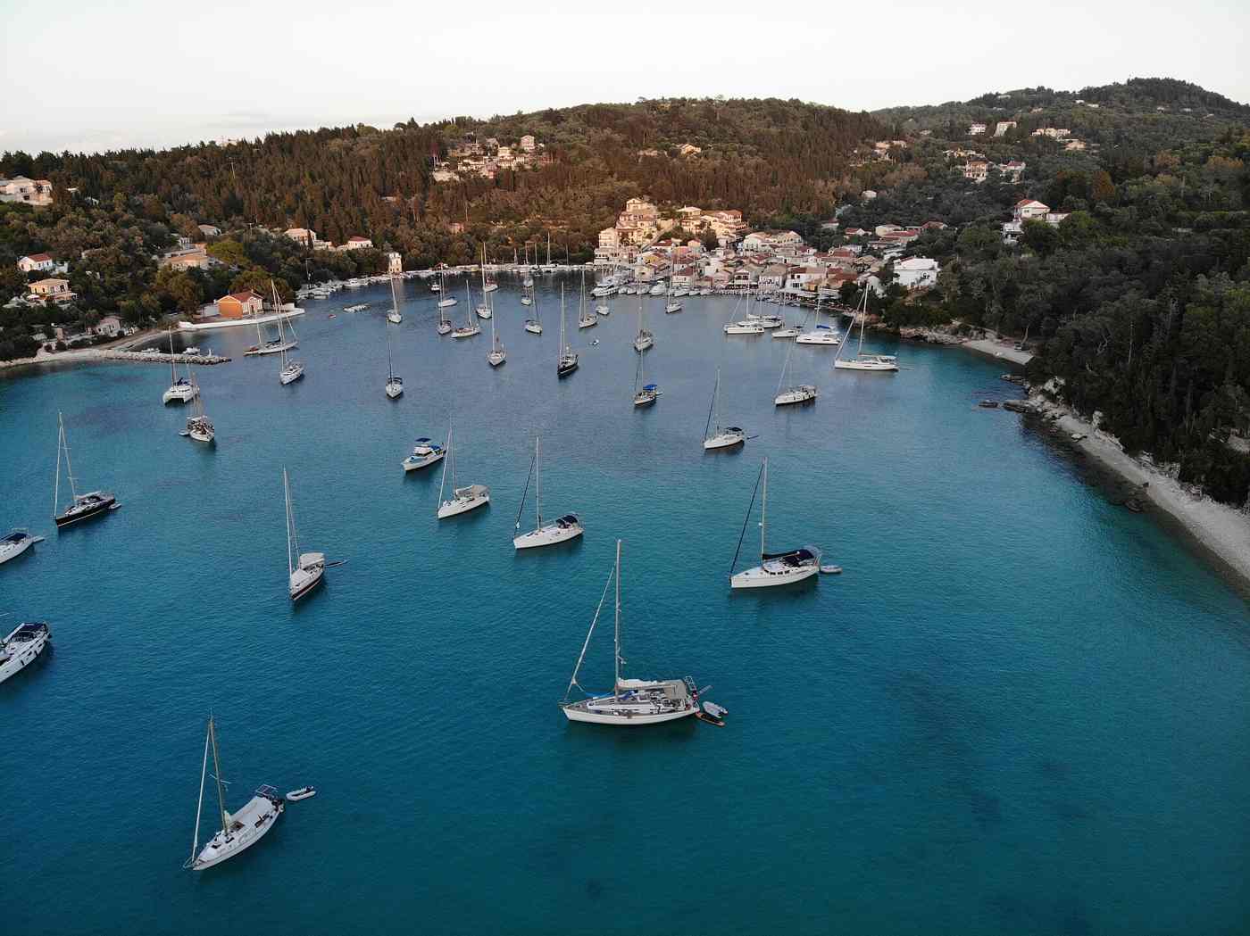 Aerial view of Lakka village and its yacht-filled bay on Paxos