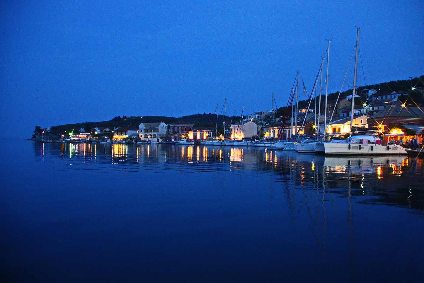 The harbour of Gaios on Paxos lit up at dusk