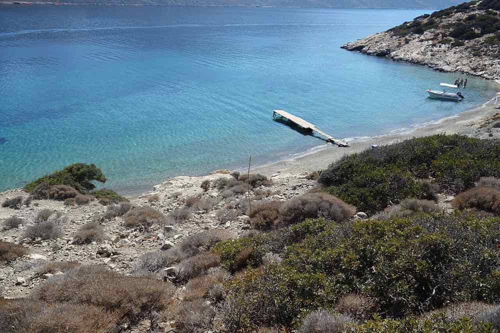A turquoise cove and jetty on the islet of Nikouria off Amorgos, in the warm summer season