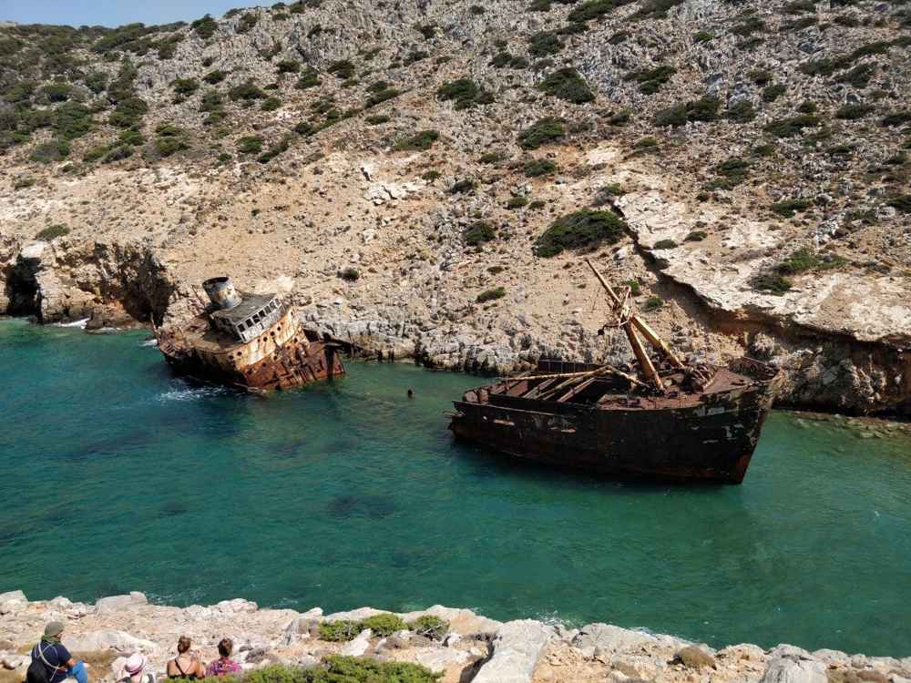 The rusting hull of the Olympia shipwreck in a turquoise bay in southern Amorgos, a Big Blue landmark