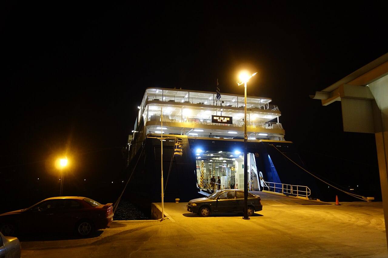 A ferry docked at the port of Katapola on Amorgos at night, cars boarding for the crossing