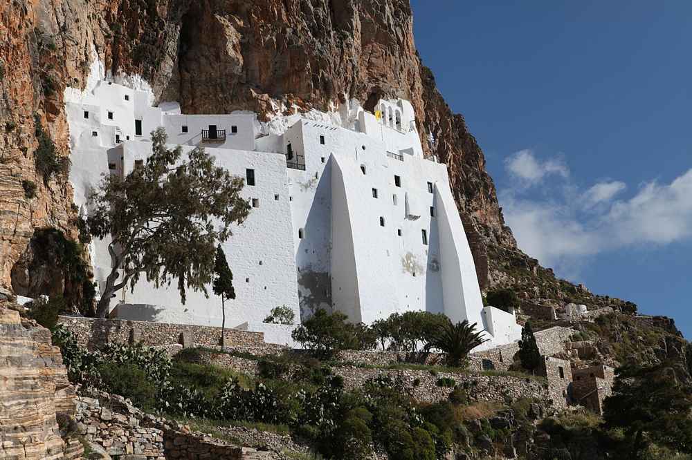 The white Hozoviotissa Monastery pressed into a sheer cliff below Chora on Amorgos