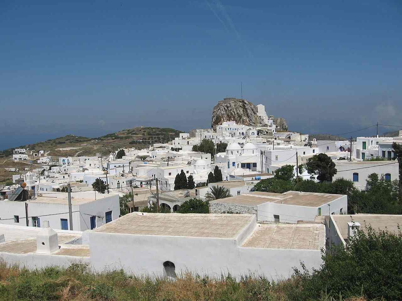 The whitewashed capital Chora of Amorgos with its castle rock rising behind the rooftops