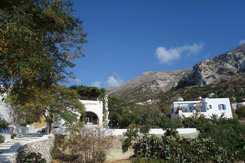 Whitewashed houses of Langada set against the green mountains above Aegiali bay on Amorgos