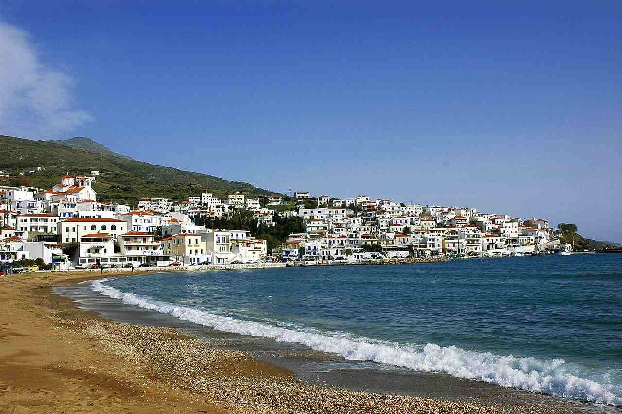 Batsi's golden village beach curving along the bay below the whitewashed houses of the resort on Andros