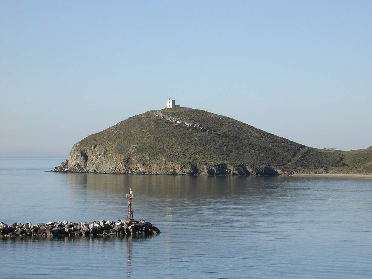 The sheltered bay of Gavrio, the ferry port on the north-west coast of Andros, with a chapel-topped headland