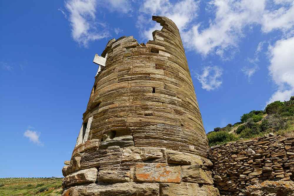 The ancient Hellenistic round tower of Agios Petros standing inland from the port of Gavrio on Andros