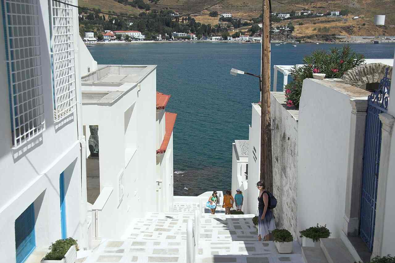 A whitewashed Chora street descending to the sea by the Museum of Modern Art on Andros