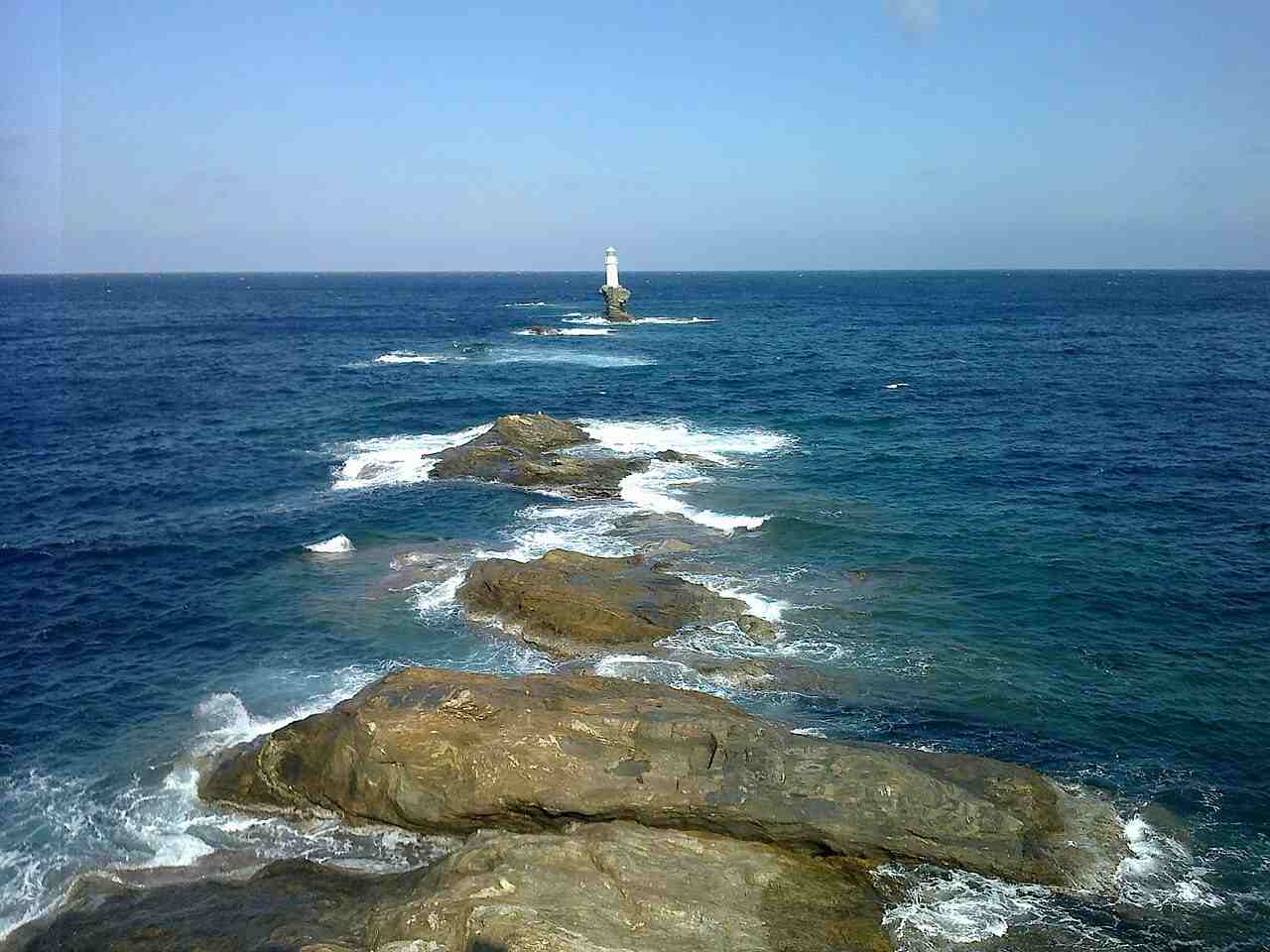 The Tourlitis lighthouse rising from its lone sea rock off the coast of Chora, Andros