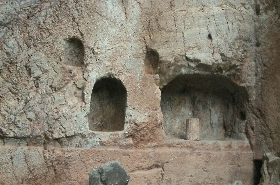 The rock-cut votive niches of the Castalian Spring carved into the Phaedriades cliff at Delphi