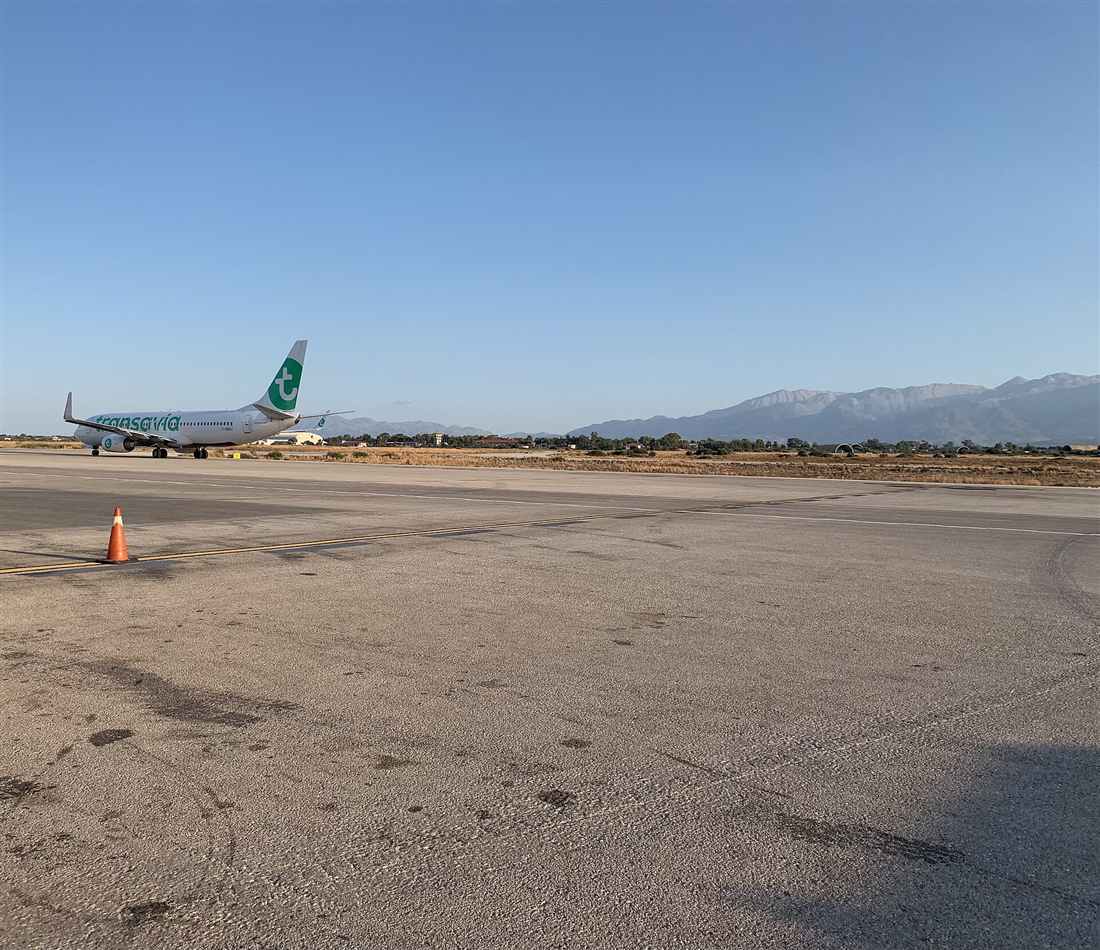 An aircraft on the apron at Chania International Airport below the White Mountains