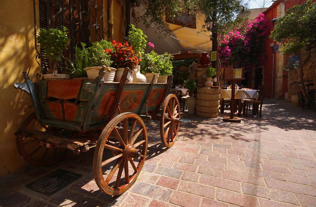 A flower-filled courtyard and taverna in the Chania old town, a top thing to do in Chania