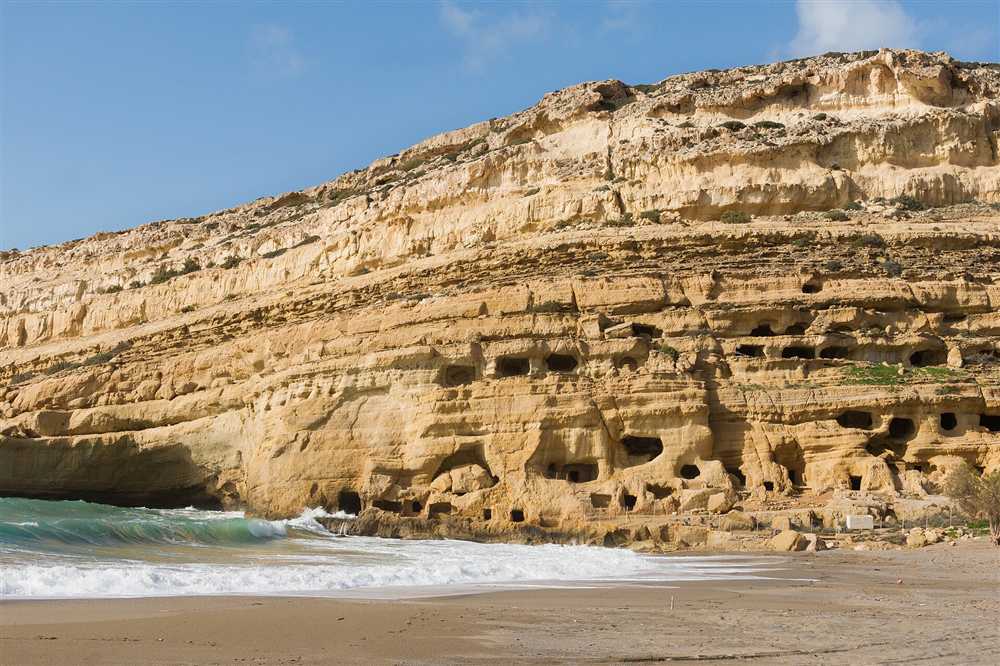 The sandstone cliff caves and sandy beach at Matala on the Gulf of Messara, a short drive from Agia Galini