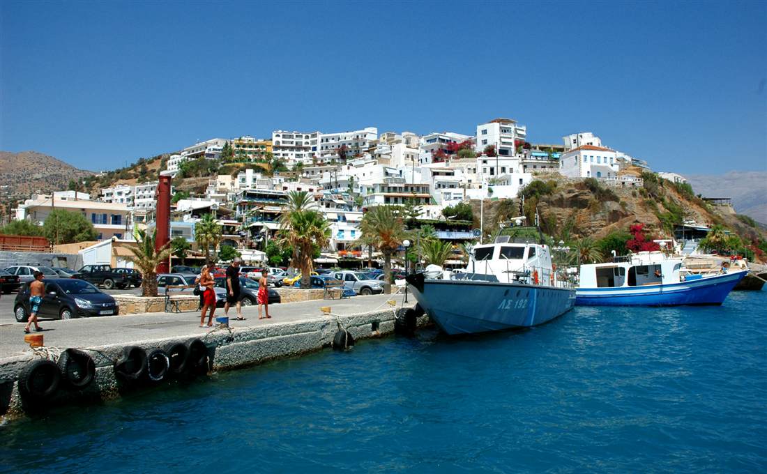 The resort of Agia Galini on the south coast of Crete, its whitewashed houses stacked up the hillside above the harbour